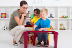 Teacher and preschool students2_teacher-helping-kindergarten-s-8813857